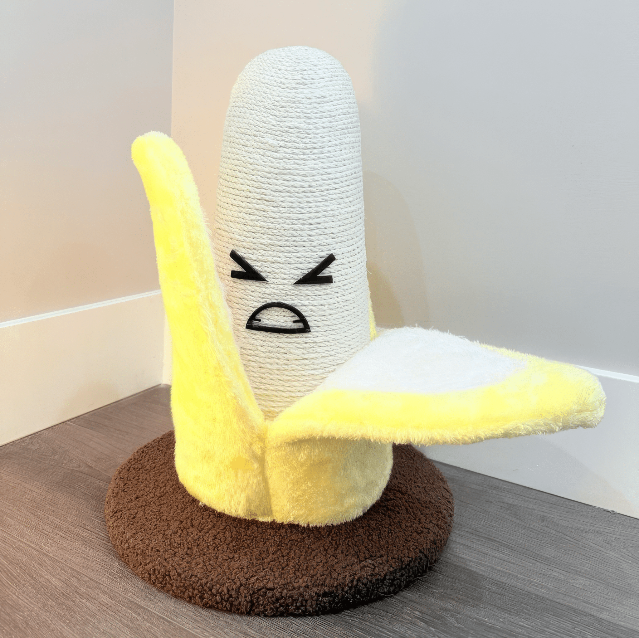 banana scratcher with a funny face on a wooden surface
