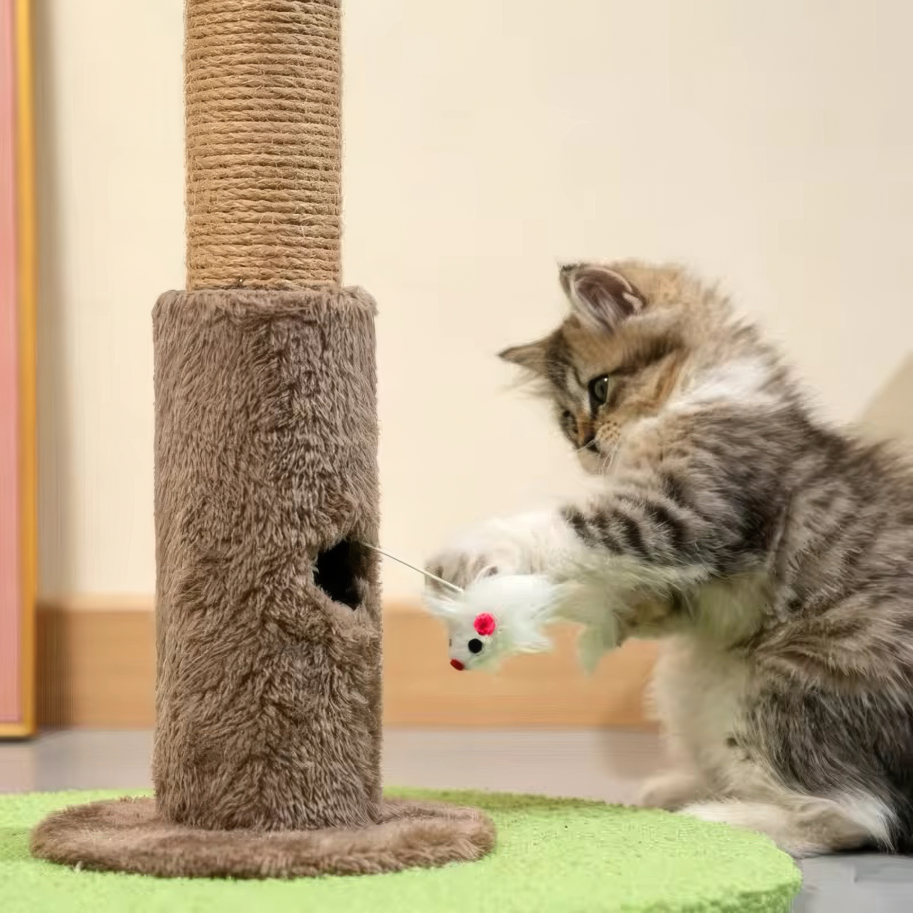 Cat playing with a mouse toy on a cat tree
